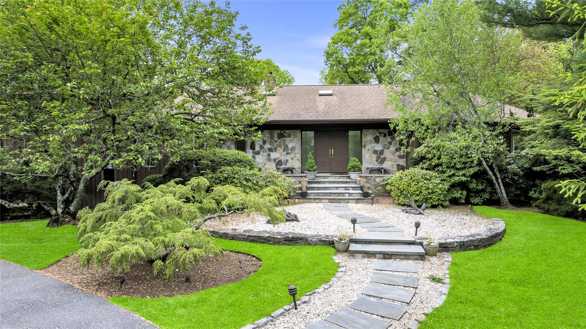 a front view of a house with a yard table and chairs
