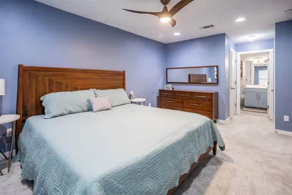 a bedroom with a bed and a television
