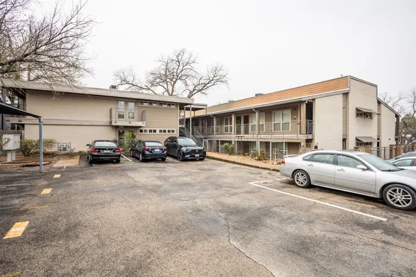 a view of a car parked in front of a white house