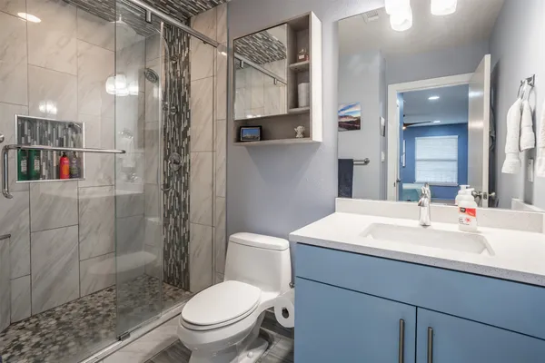 a bathroom with a sink toilet and shower