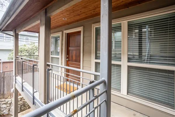 a view of a balcony with a floor to ceiling window