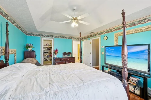 a bedroom with a bed and a chandelier