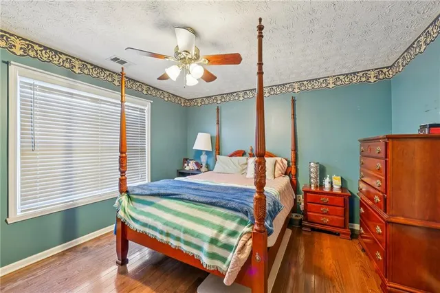 a bedroom with bed and windows