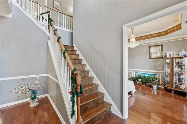 a view of entryway and hall with wooden floor