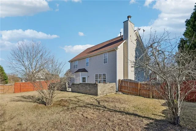 a view of a house with a snow in the yard