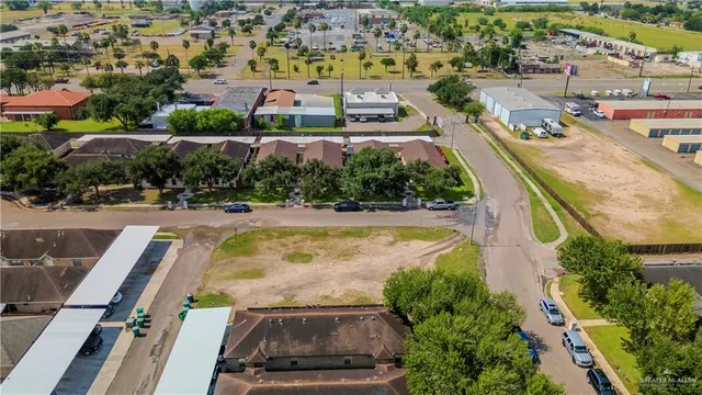 an aerial view of residential houses with outdoor space and swimming pool