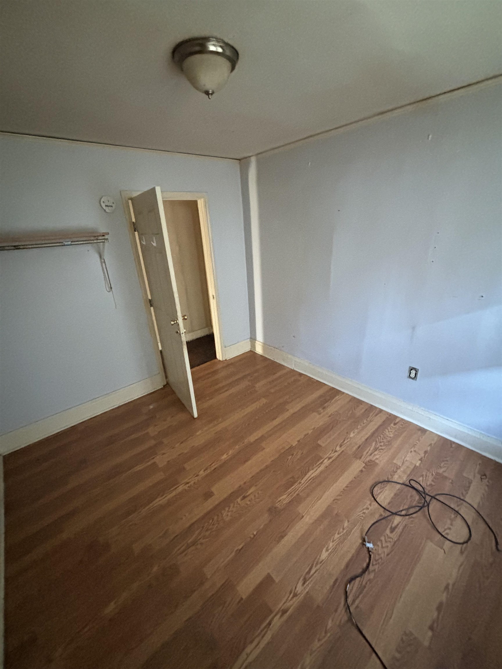 1920 Oliver Avenue Memphis, TN 38104 - Photo 16 of 19 Unfurnished bedroom featuring baseboards and wood finished floors