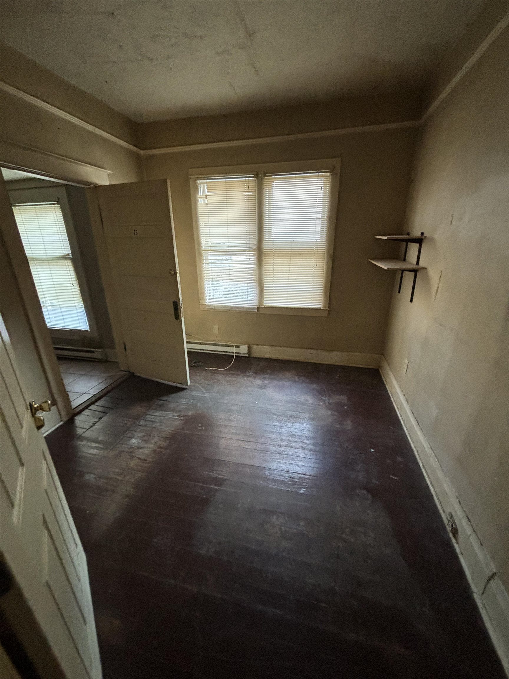 1920 Oliver Avenue Memphis, TN 38104 - Photo 18 of 19 Interior space with dark wood-style floors, baseboard heating, and baseboards