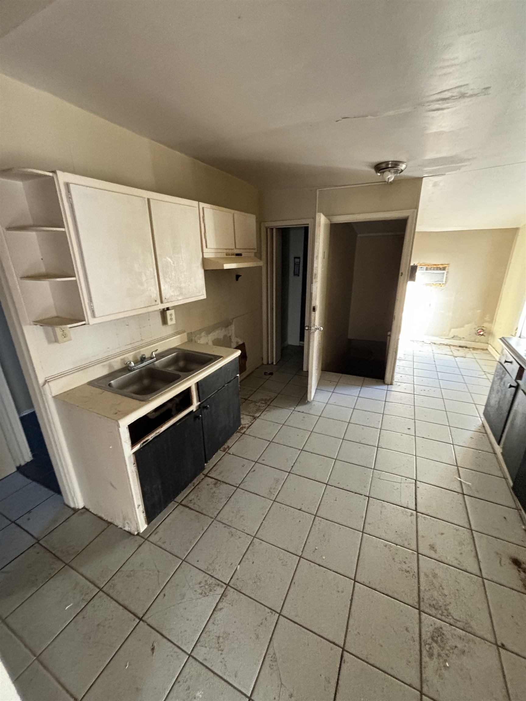 1920 Oliver Avenue Memphis, TN 38104 - Photo 6 of 19 Kitchen with white cabinetry, light countertops, a sink, and light tile patterned floors