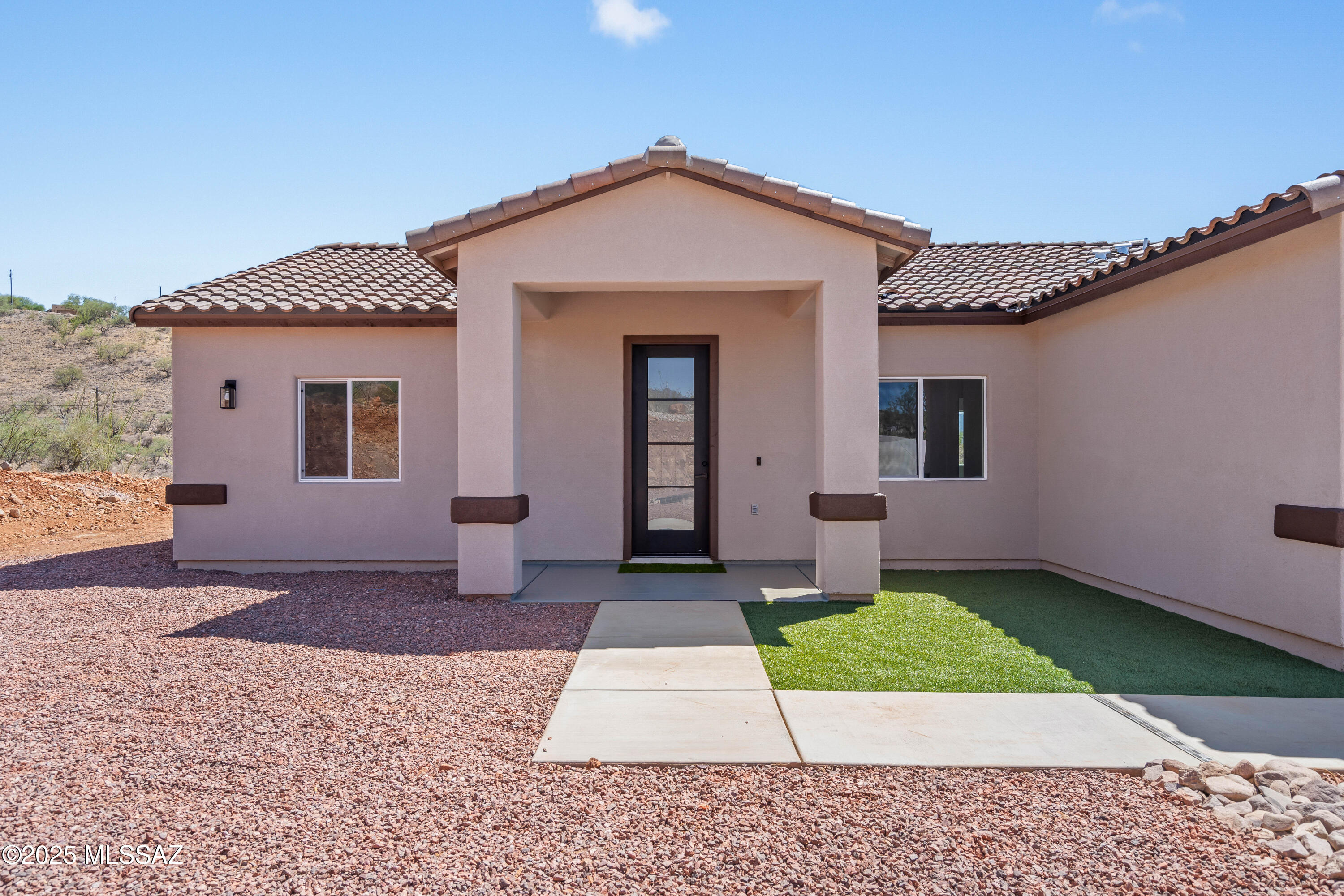 1667 Ave Calamar Rio Rico, AZ 85648 - Photo 5 of 33 a front view of a house with a yard and garage
