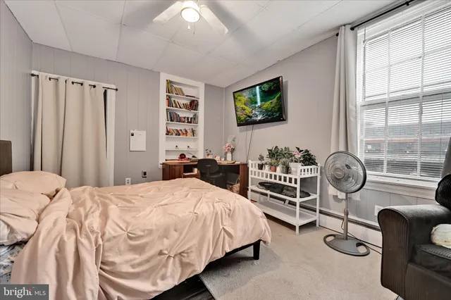 a bedroom with bed and a window