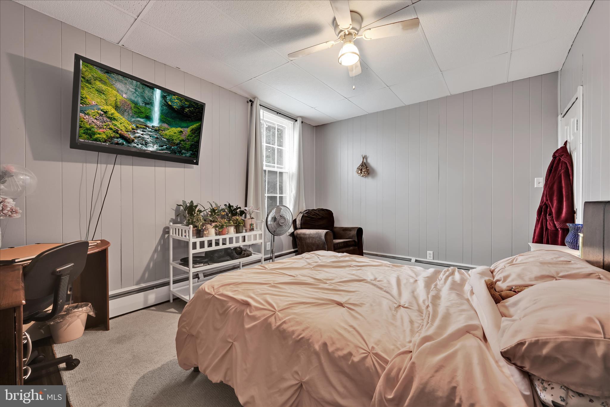 33 North 10th Street Lebanon, PA 17046 - Photo 14 of 31 a bedroom with a bed a computer on the desk and a book shelf