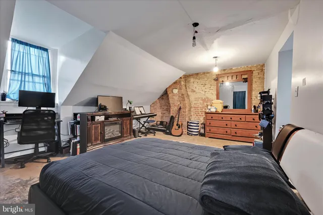 a bed room with a bed and a television