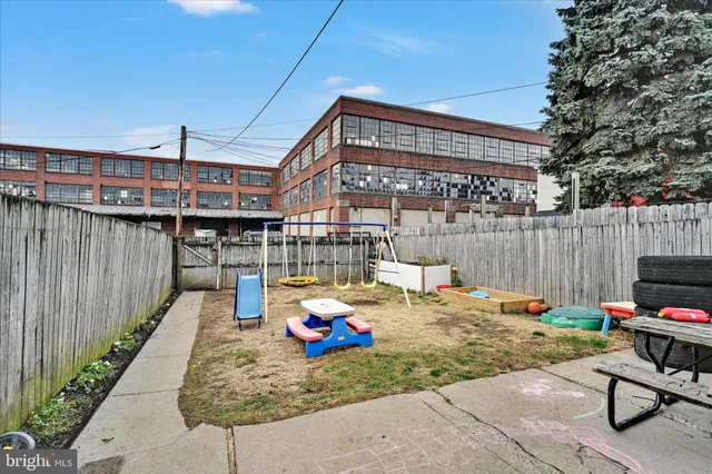 a backyard of a house with barbeque oven table and chairs
