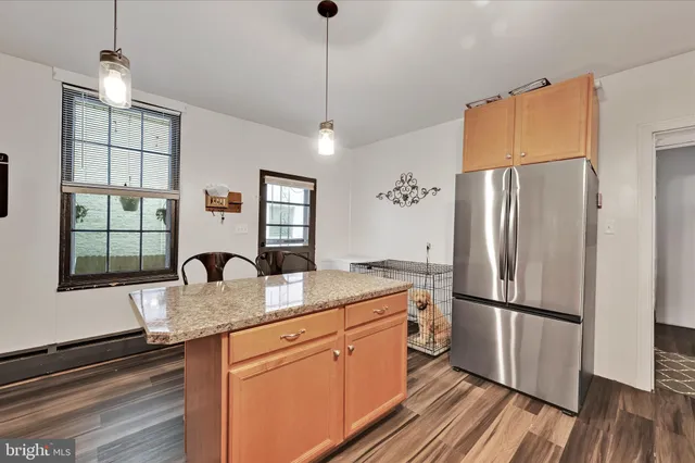 a kitchen with stainless steel appliances granite countertop a refrigerator a sink and a stove