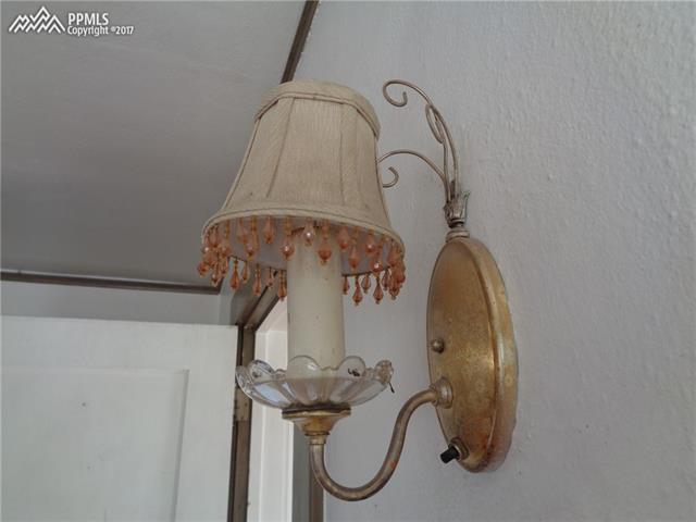 318 West Cheyenne Road Colorado Springs, CO 80906 - Photo 19 of 36 Another piece from the past...Wall sconce/lamp present in the living room.