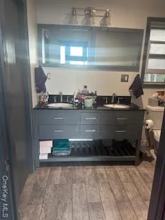 a kitchen with stainless steel appliances granite countertop a refrigerator a stove and a wooden floors