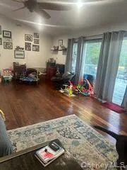 a living room with furniture rug and wooden floor