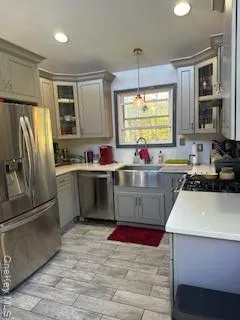 a kitchen with stainless steel appliances granite countertop a sink stove refrigerator and cabinets