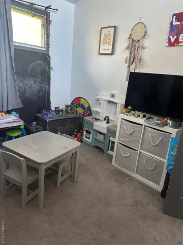 a room with furniture and a flat screen tv