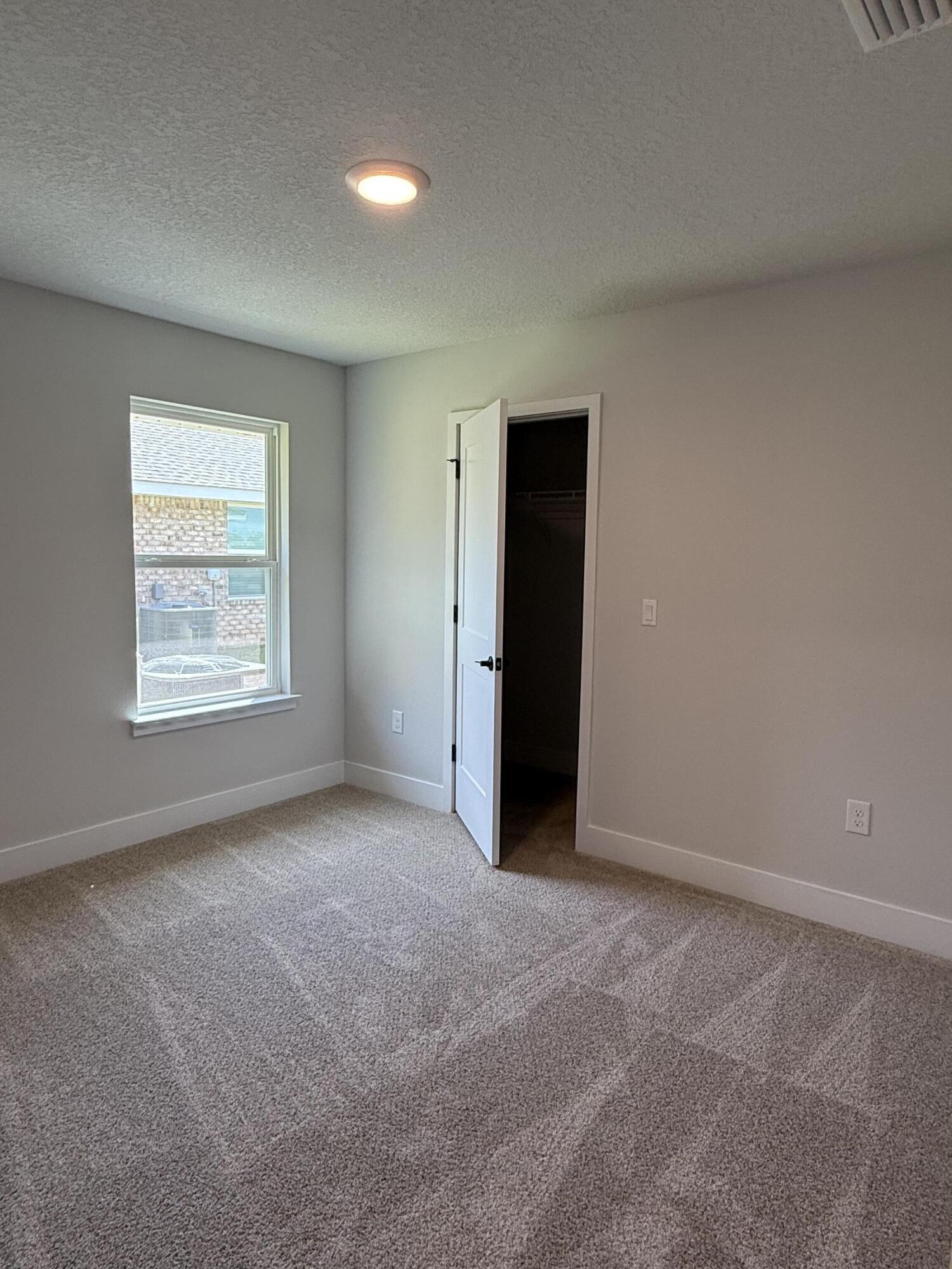 2411 Aleia Lane Crestview, FL 32536 - Photo 12 of 21 an empty room with windows and closet