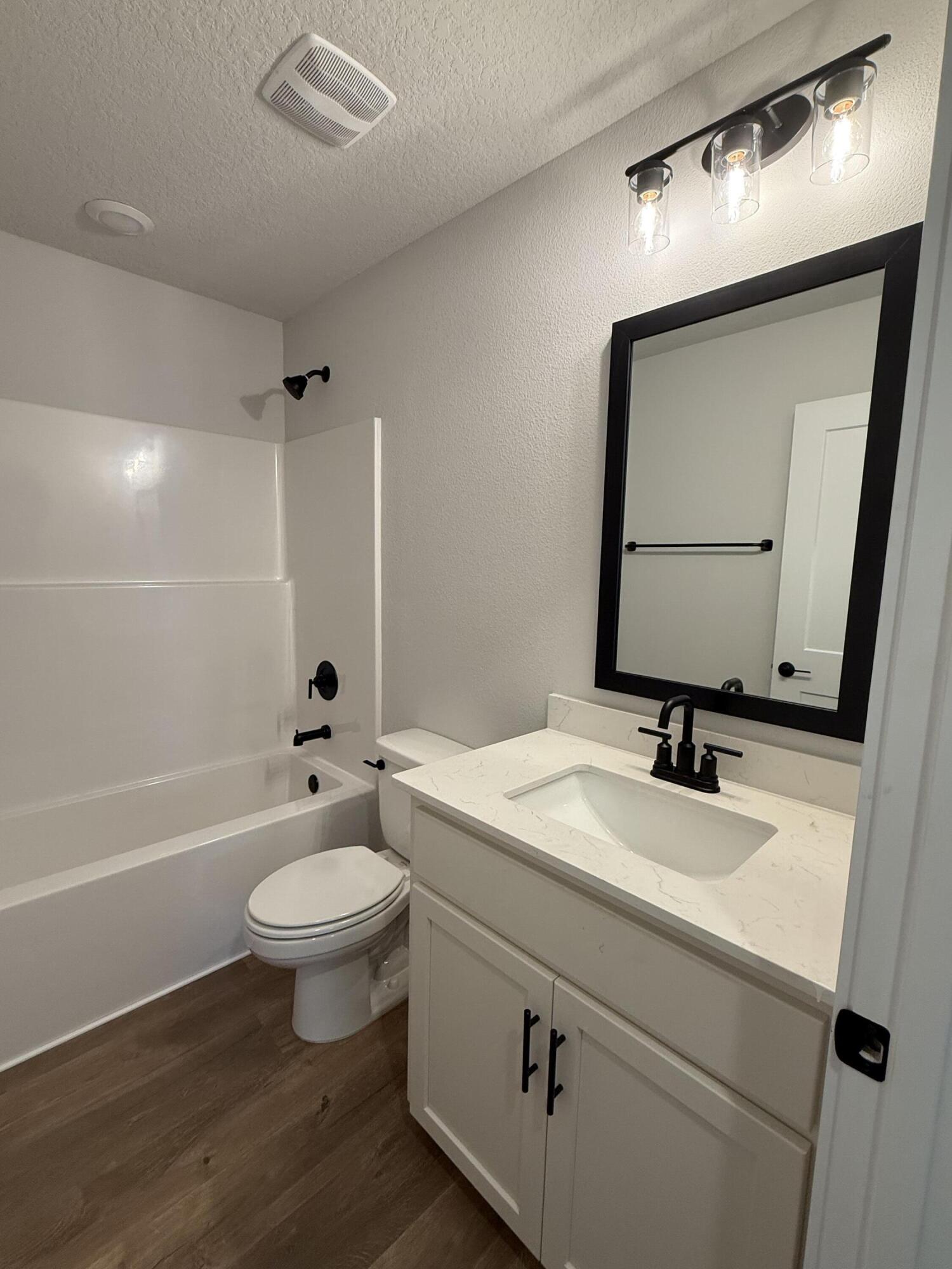 2411 Aleia Lane Crestview, FL 32536 - Photo 13 of 21 a bathroom with a sink toilet a mirror and bathtub