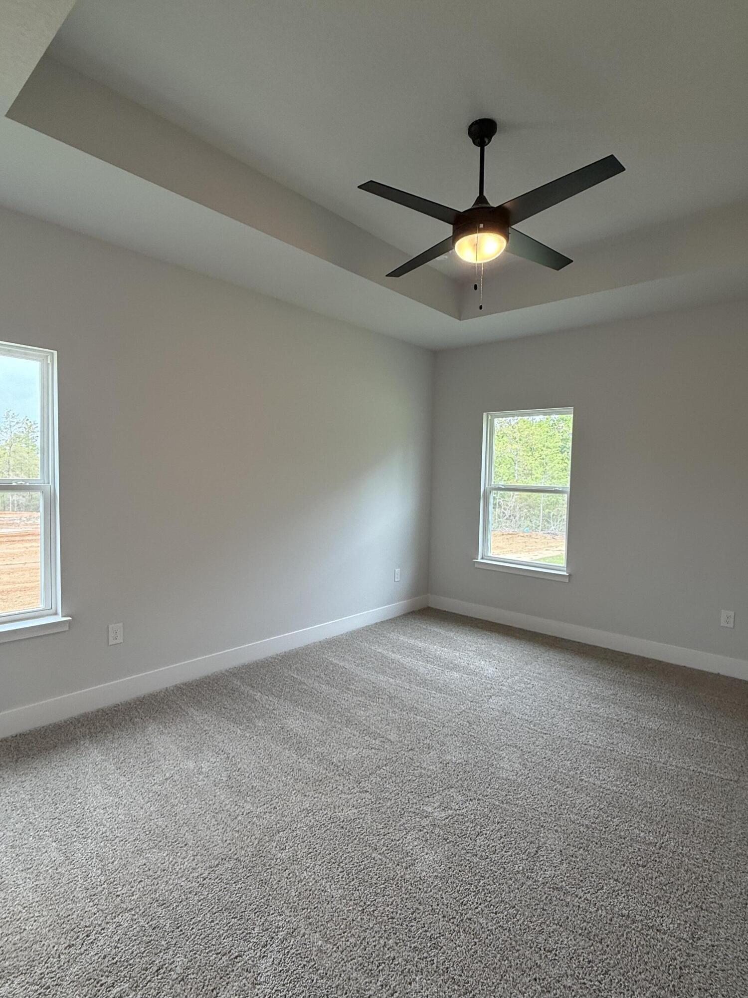 2411 Aleia Lane Crestview, FL 32536 - Photo 15 of 28 an empty room with windows and fan