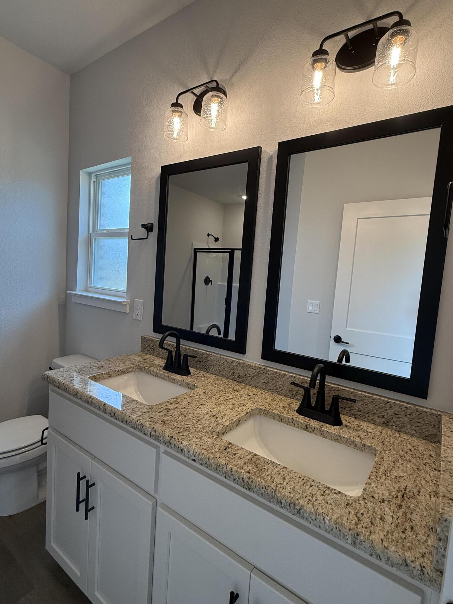 2411 Aleia Lane Crestview, FL 32536 - Photo 17 of 28 a bathroom with a granite countertop sink and a mirror
