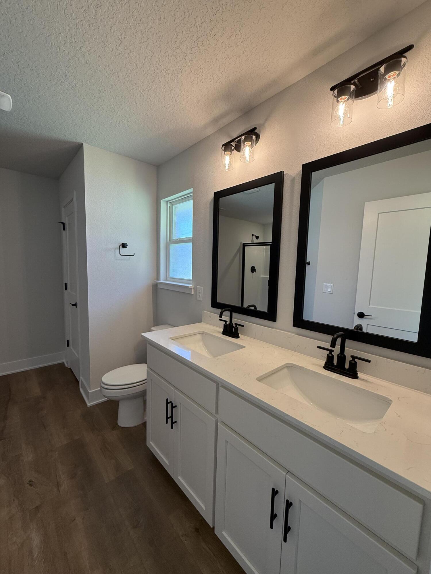 2411 Aleia Lane Crestview, FL 32536 - Photo 18 of 21 a bathroom with a double vanity sink and a mirror