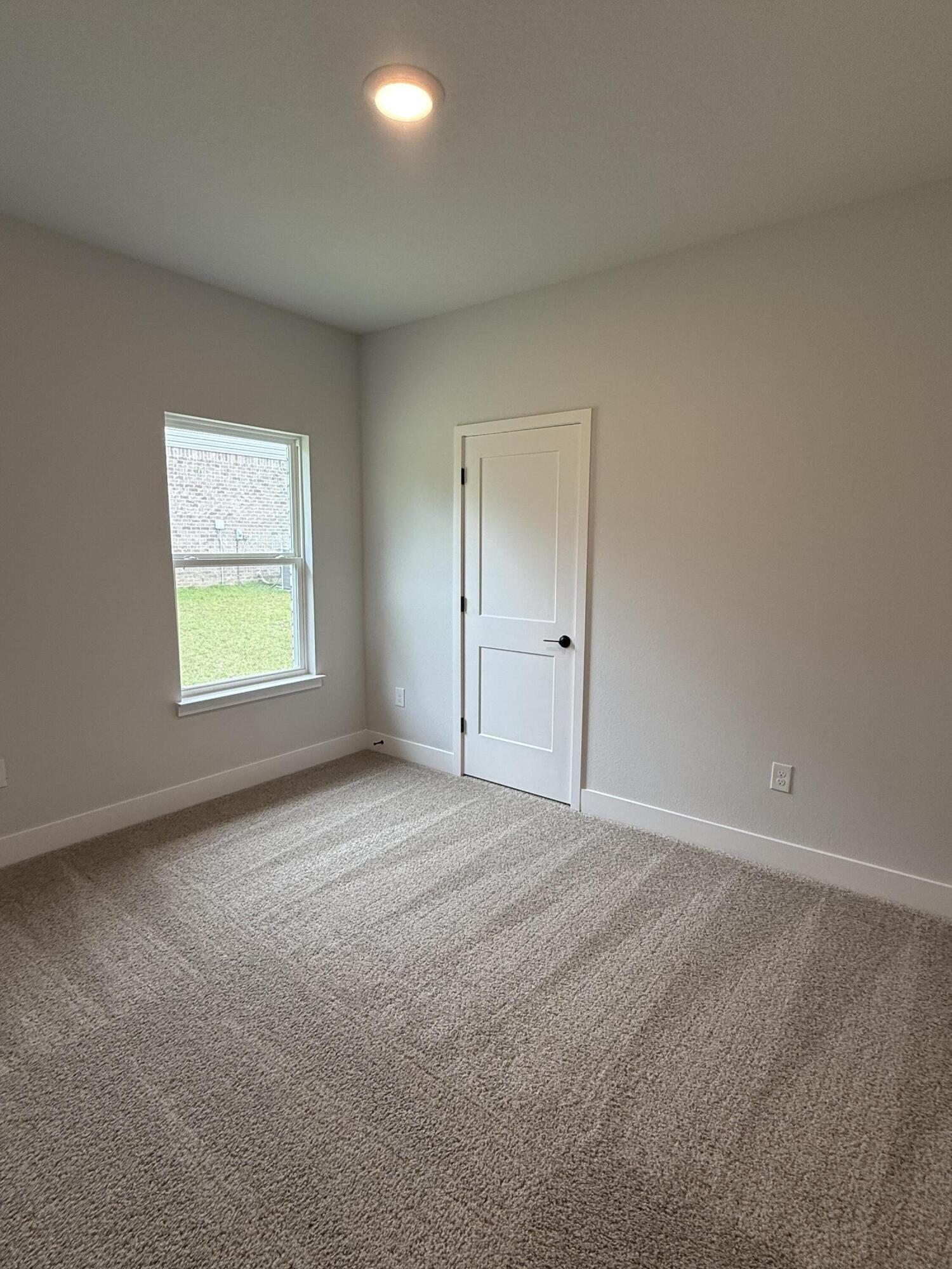 2411 Aleia Lane Crestview, FL 32536 - Photo 18 of 28 an empty room with windows and closet