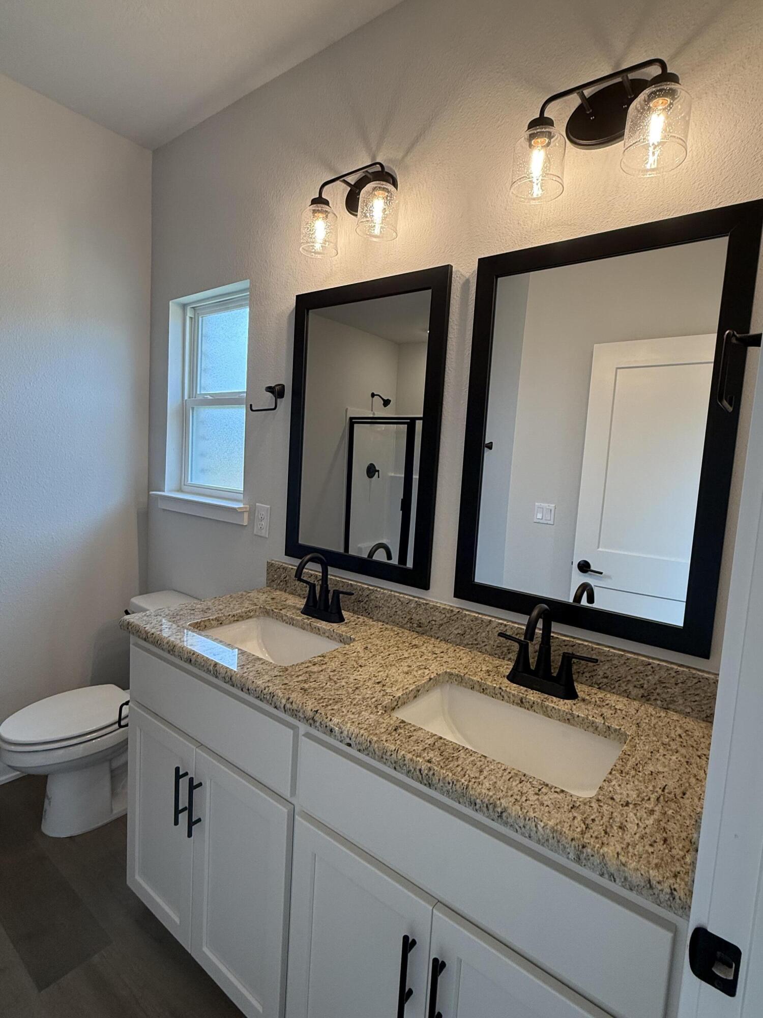 2411 Aleia Lane Crestview, FL 32536 - Photo 19 of 28 a bathroom with a granite countertop sink and a mirror