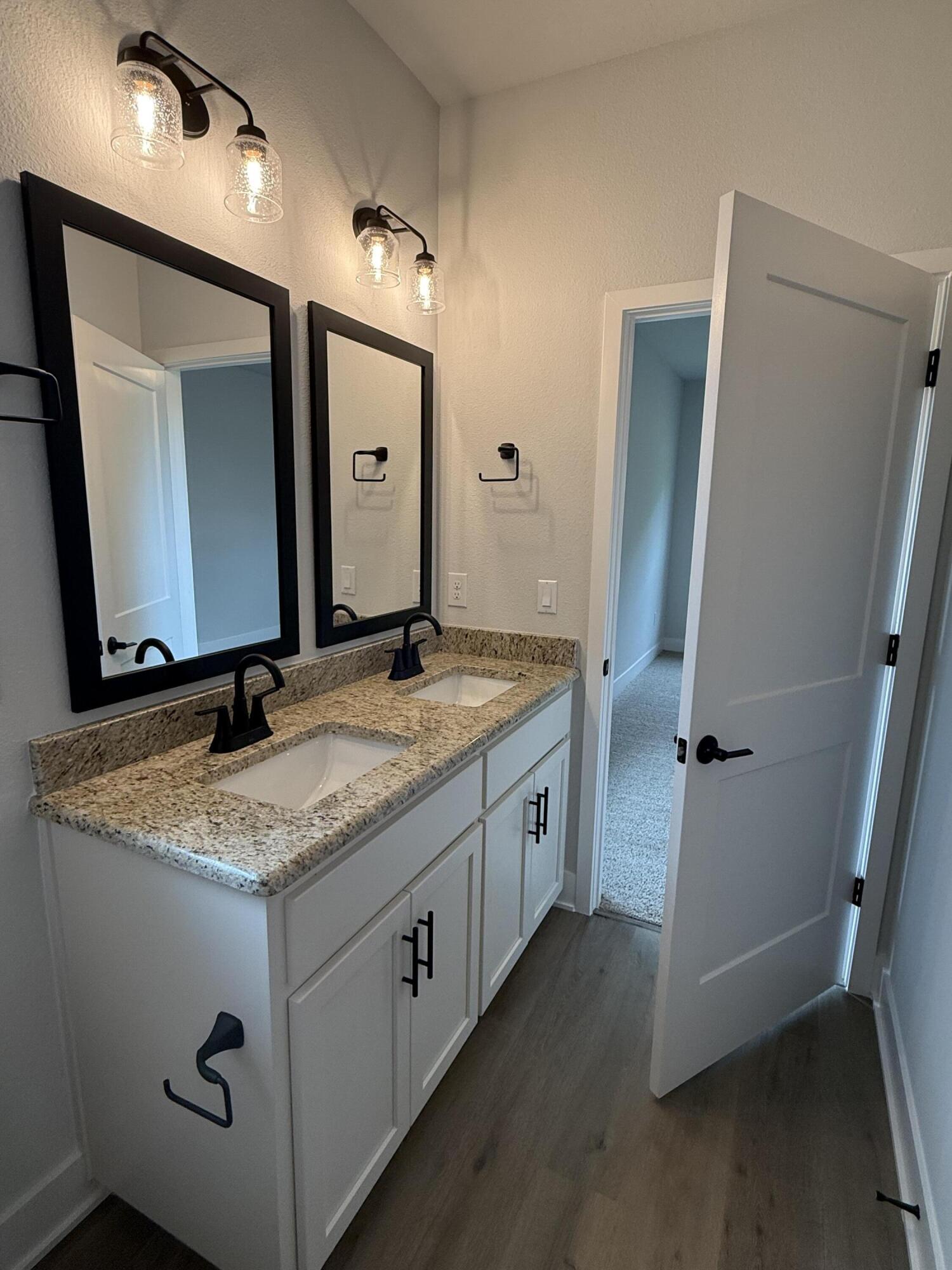 2411 Aleia Lane Crestview, FL 32536 - Photo 20 of 28 a bathroom with a granite countertop sink and a mirror