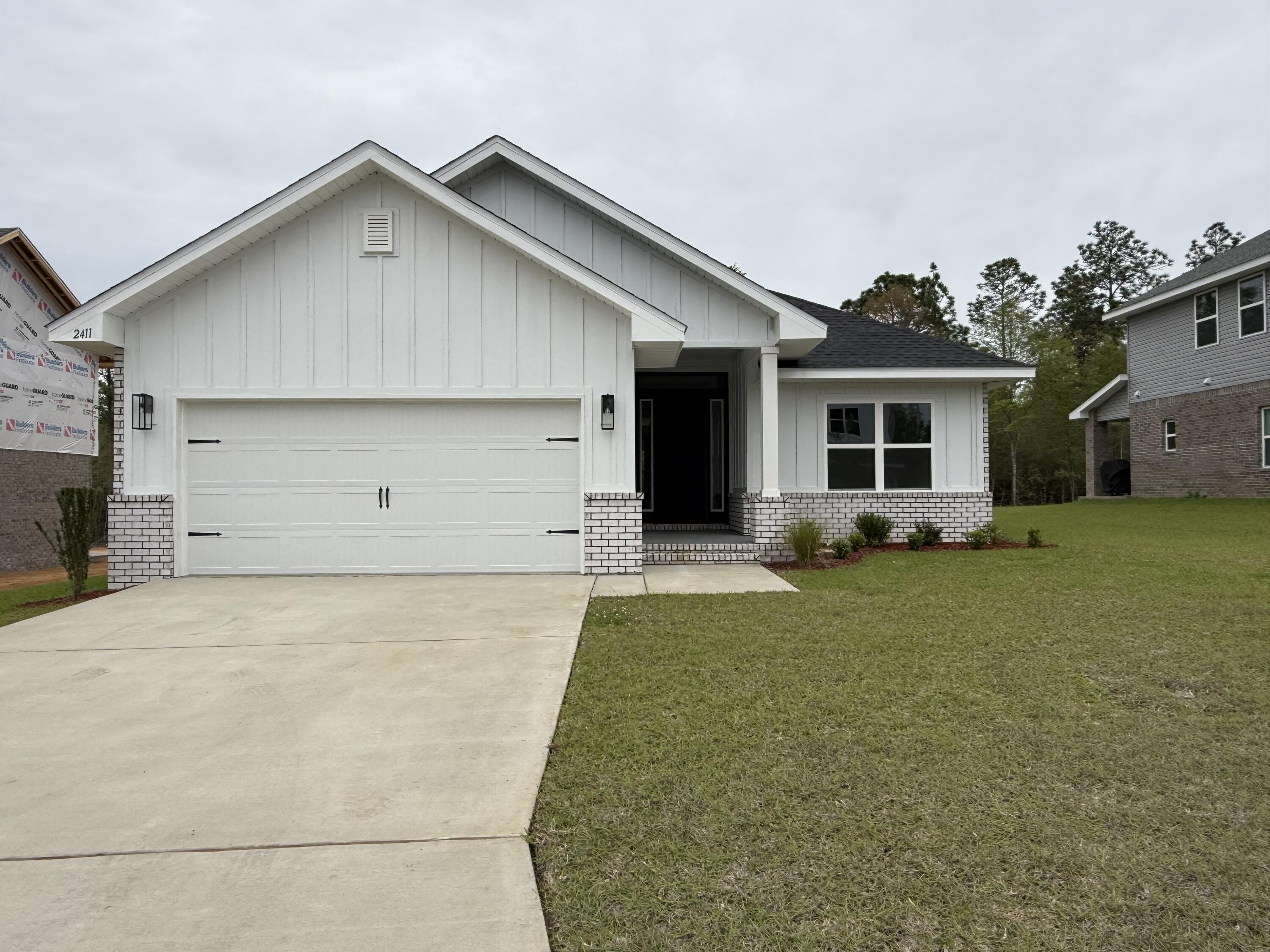 2411 Aleia Lane Crestview, FL 32536 - Photo 3 of 28 a view of a house with a yard and garage