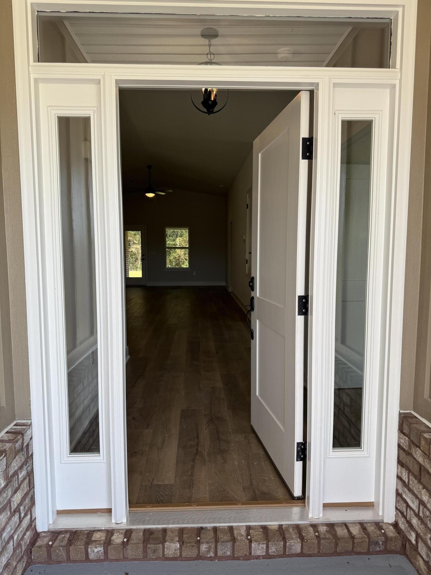 2411 Aleia Lane Crestview, FL 32536 - Photo 4 of 21 a view of a hallway with a glass door and a window