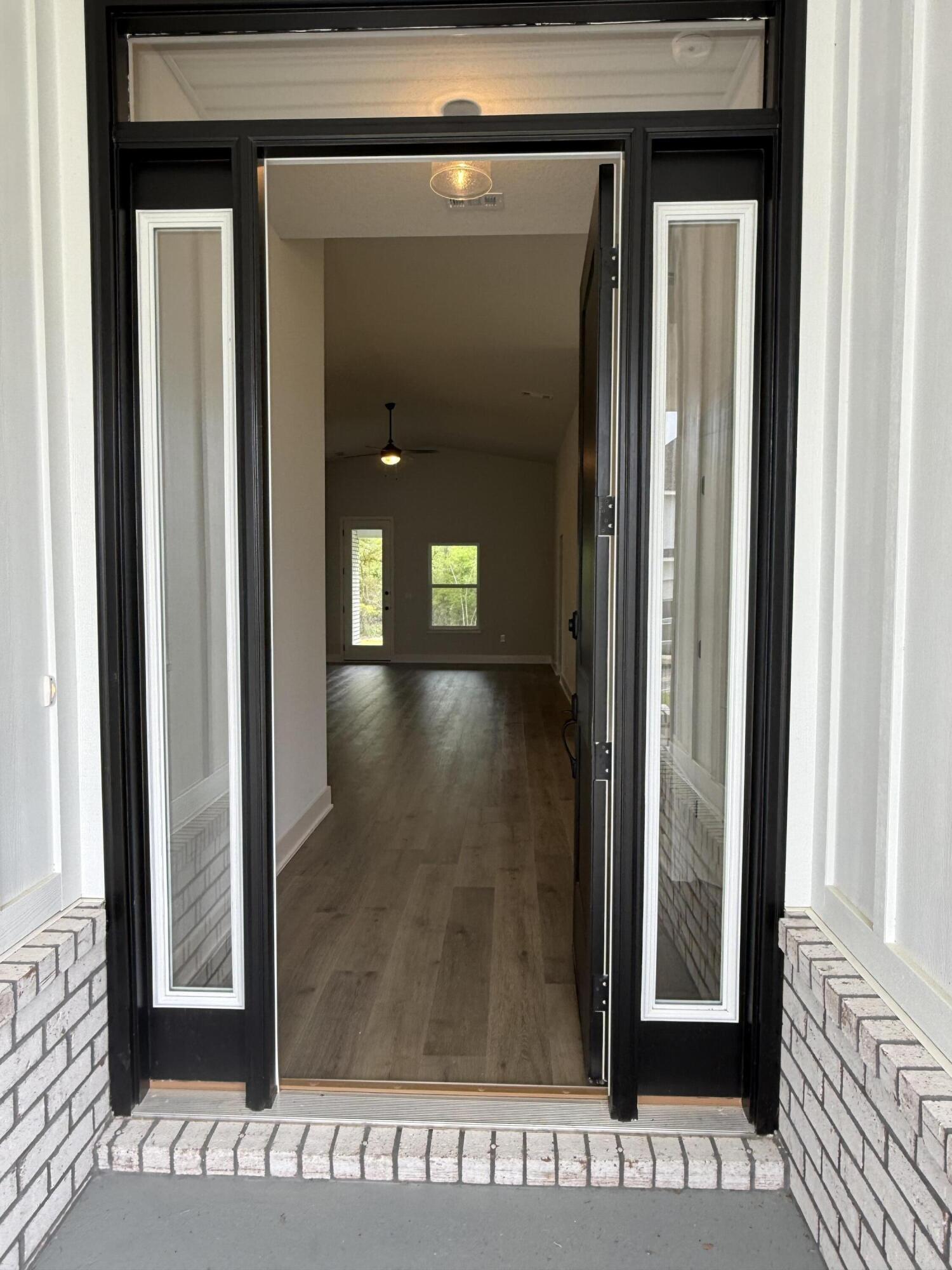 2411 Aleia Lane Crestview, FL 32536 - Photo 5 of 28 a view of a hallway with wooden floor