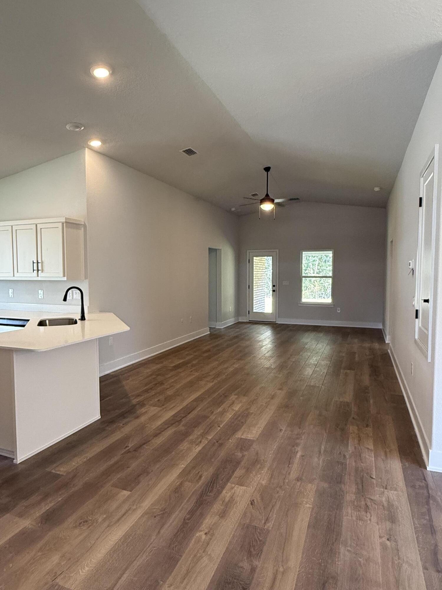 2411 Aleia Lane Crestview, FL 32536 - Photo 7 of 21 a view of an empty room with window and wooden floor
