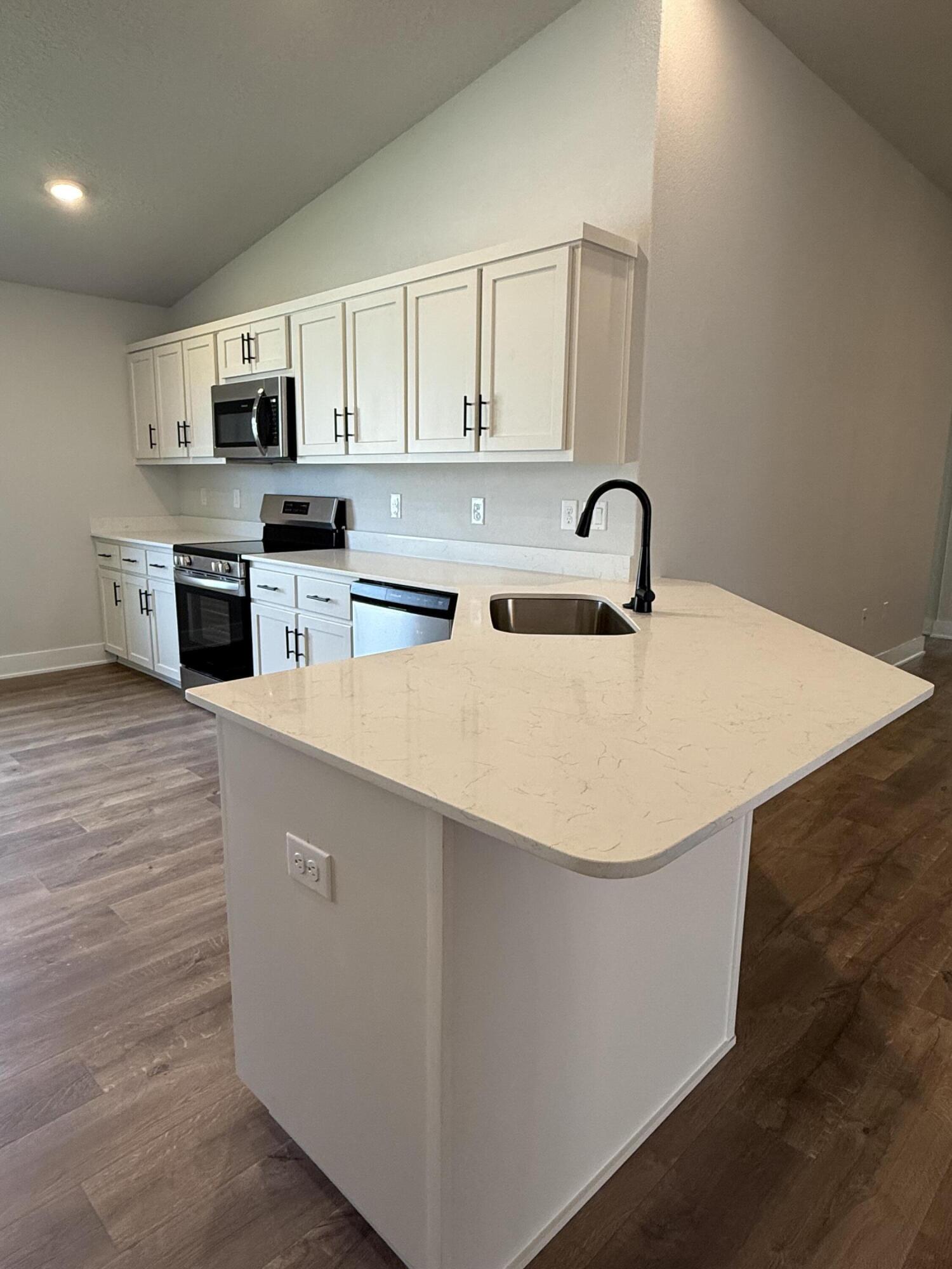 2411 Aleia Lane Crestview, FL 32536 - Photo 8 of 21 a kitchen with stainless steel appliances a refrigerator sink and white cabinets