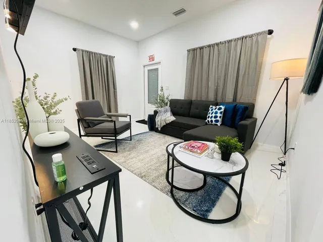 a living room with furniture and a window