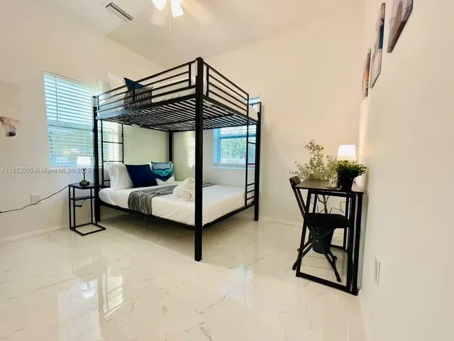 a bedroom with furniture and a window