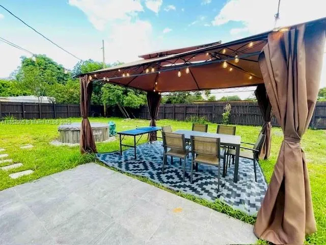 a view of a chair and table in the garden