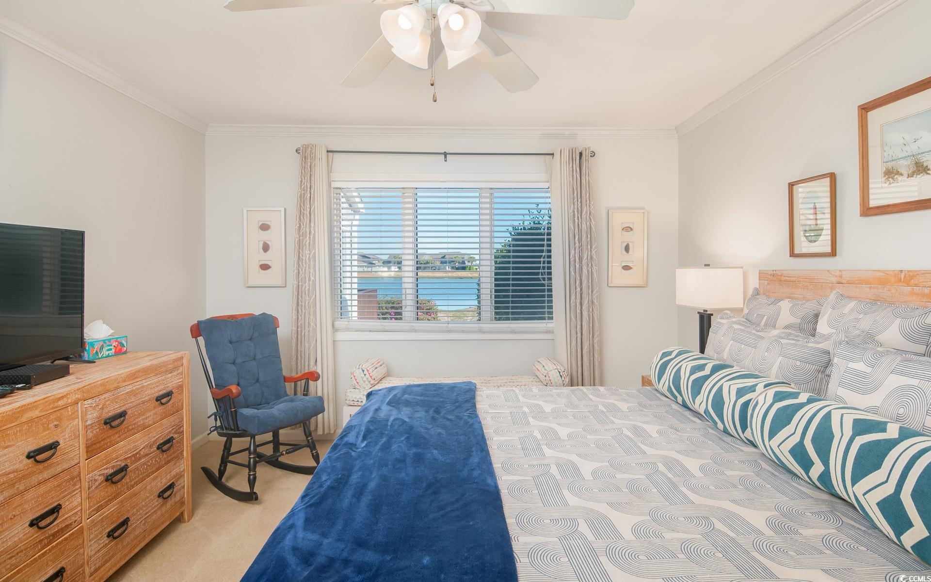 27 Pheasant Loop, Unit 293 Georgetown, SC 29440 - Photo 12 of 23 Bedroom with a water view, light colored carpet, ceiling fan, and ornamental molding