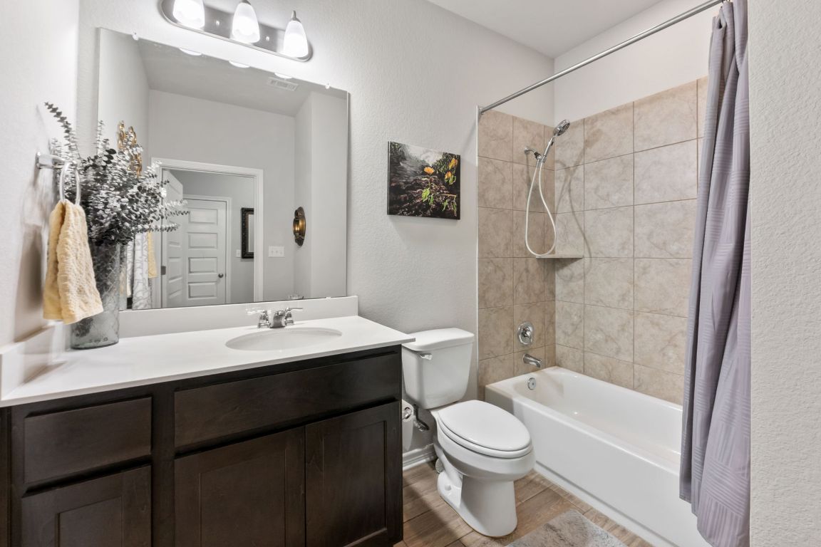 232 Syrah Court Leander, TX 78641 - Photo 13 of 37 a bathroom with a sink a toilet and shower