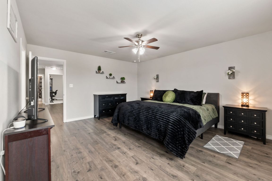 232 Syrah Court Leander, TX 78641 - Photo 15 of 37 a bedroom with a bed and a chandelier