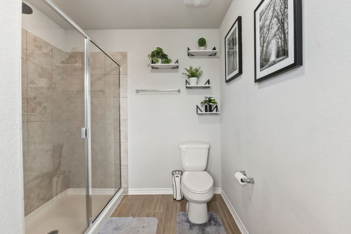 232 Syrah Court Leander, TX 78641 - Photo 18 of 37 a bathroom with a toilet and a shower