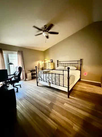 a view of a room with wooden floor and stairs