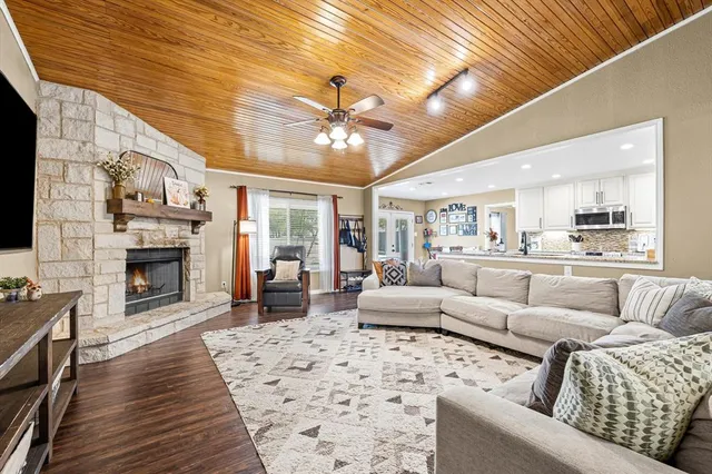 a living room with furniture kitchen view and a fireplace