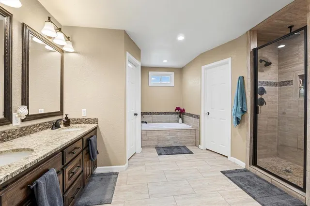 a bathroom with a granite countertop sink mirror and shower