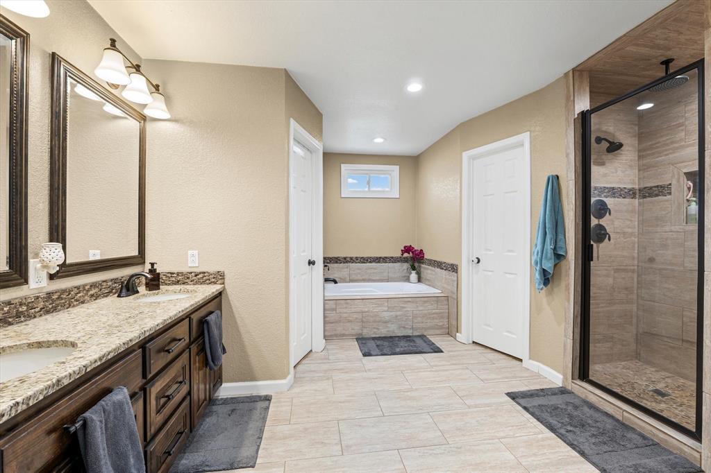134 Thiele Road Lorena, TX 76655 - Photo 16 of 37 a bathroom with a granite countertop sink mirror and shower