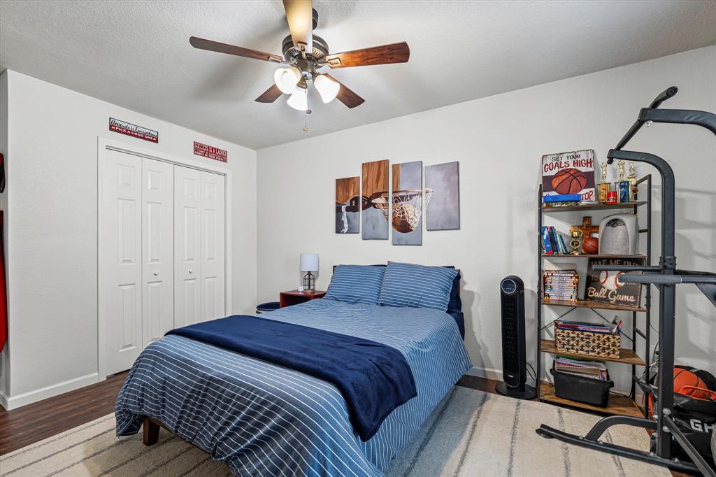 134 Thiele Road Lorena, TX 76655 - Photo 22 of 37 a bedroom with bed and wooden floor