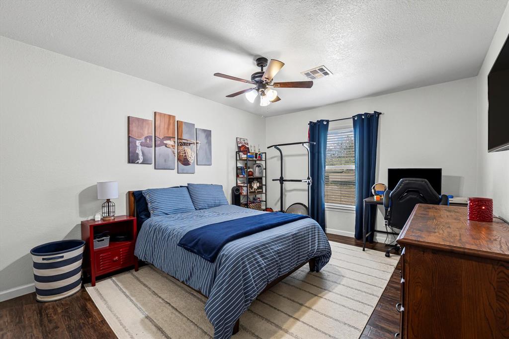 134 Thiele Road Lorena, TX 76655 - Photo 23 of 37 a bedroom with a bed and wooden floor